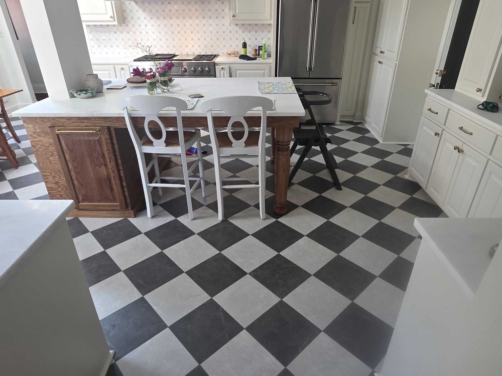 Kitchen island and dining area over a black and white checkerboard tile floor