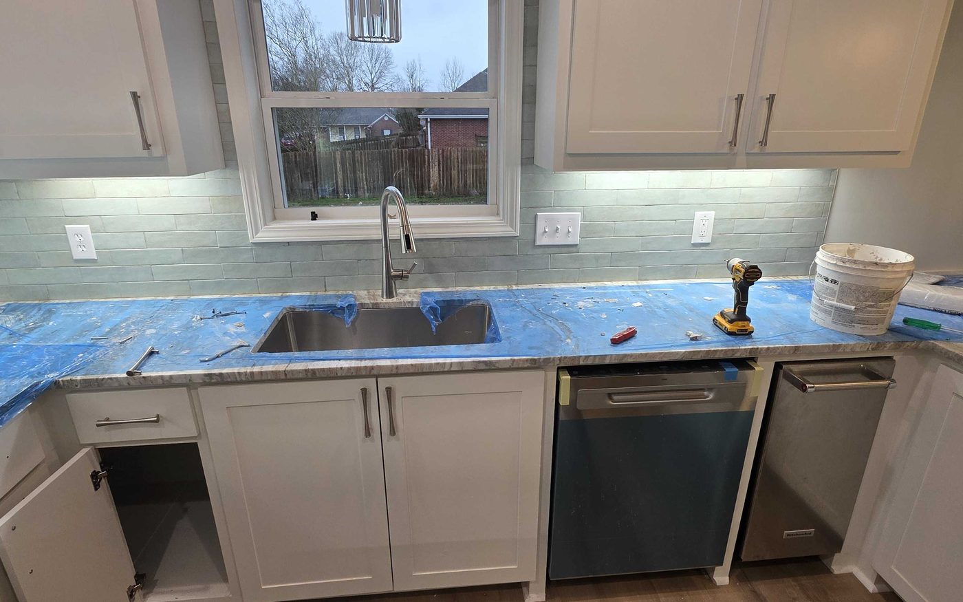 Kitchen mid job with the counters masked off and covered during install