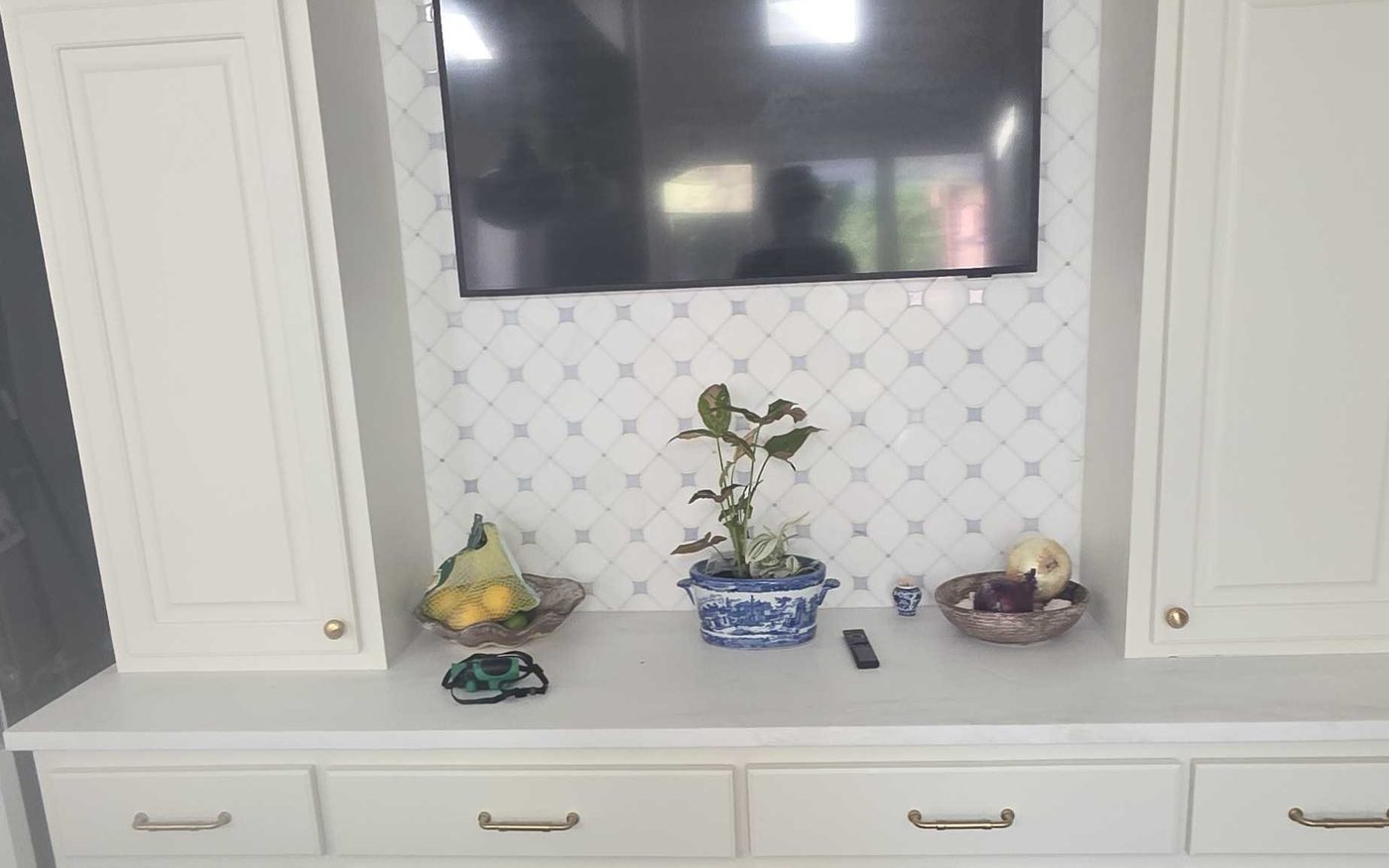 Built in cabinetry and trim surrounding a wall mounted television