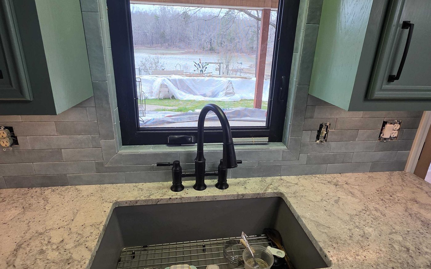 New sink and faucet set into a stone counter