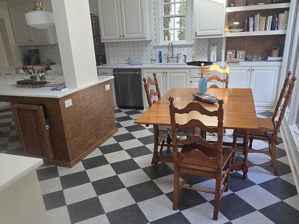 Checkerboard tile floor running from the kitchen into the dining room